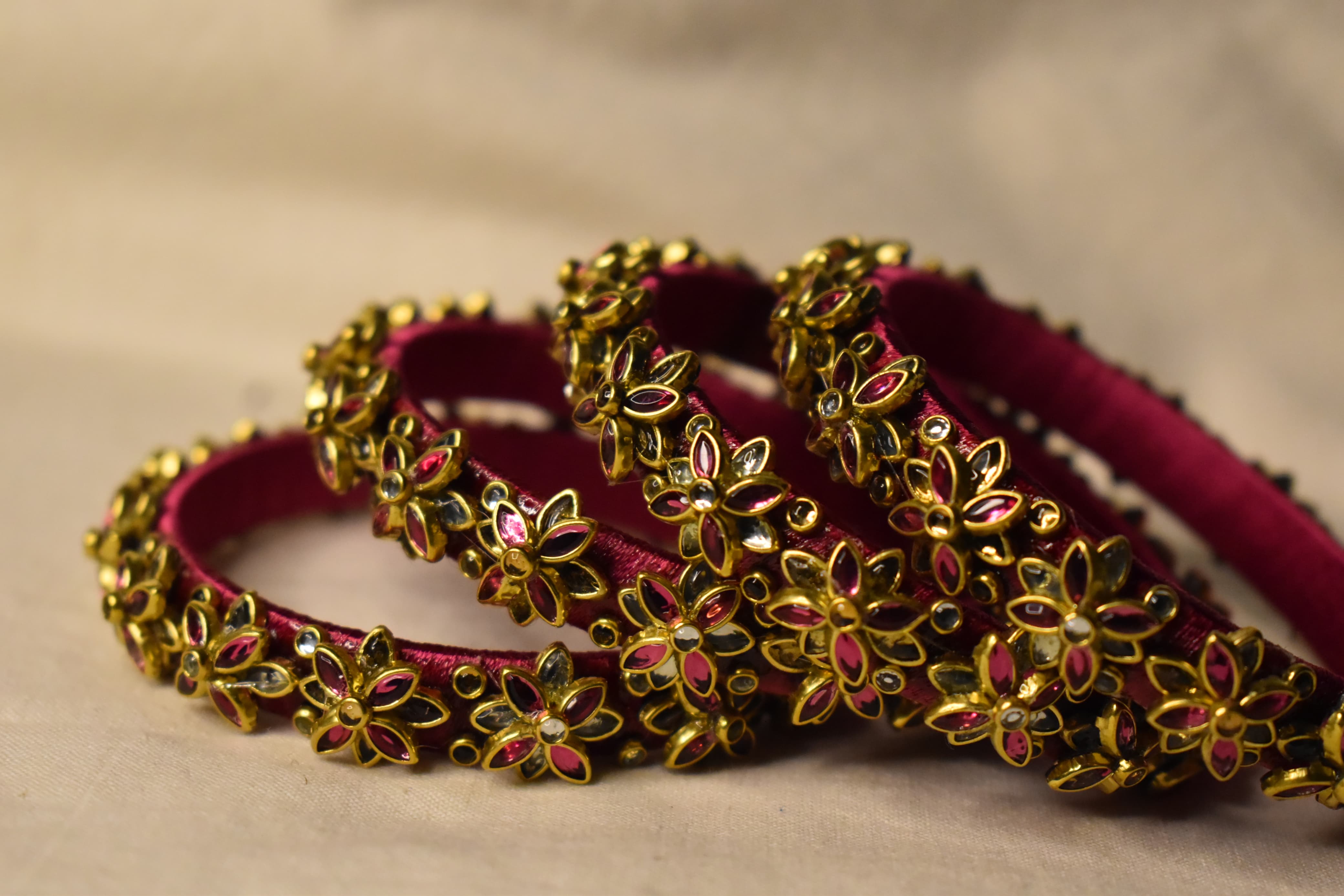 Maroon floral wedding bangle set with gold accents for engagement and reception